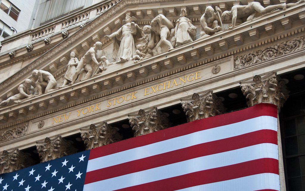 The New York Stock Exchange facade with an American flag