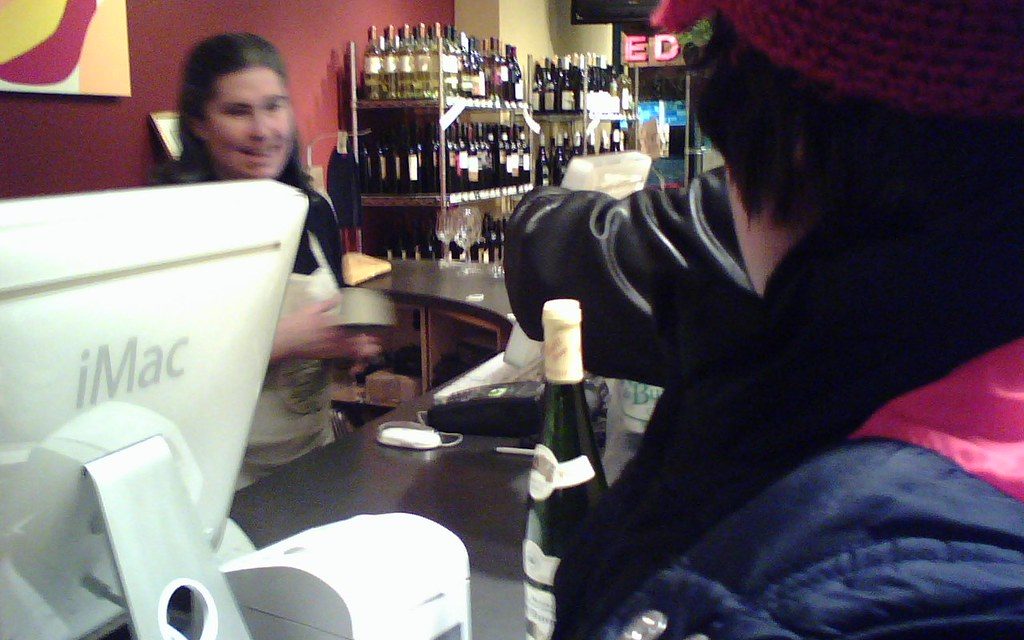 A cashier helping a customer at a store counter