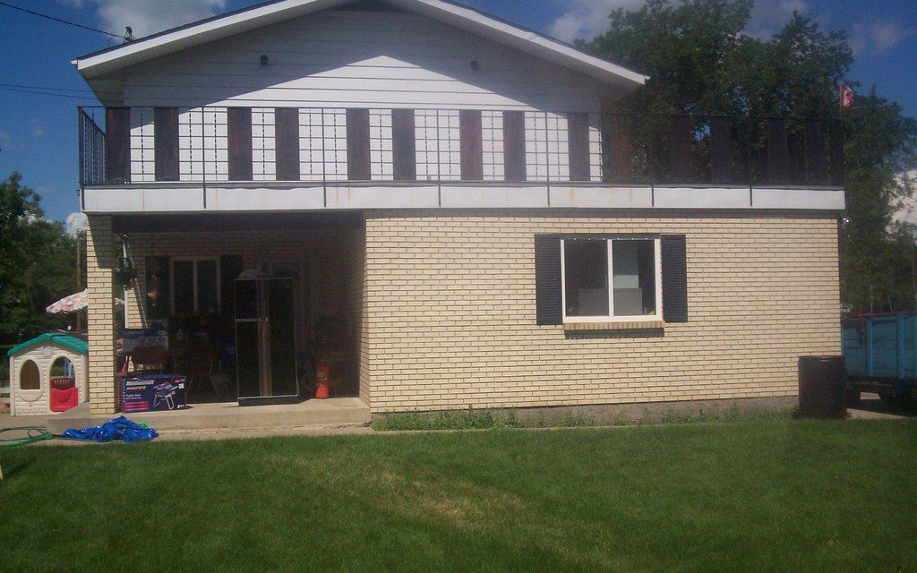 A two-story suburban house with a lawn