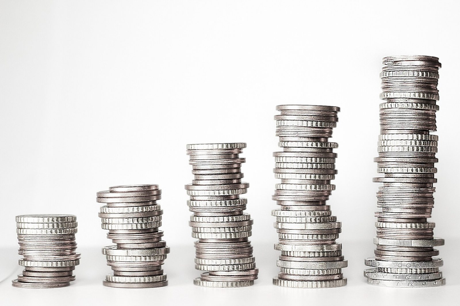 Stacks of coins growing taller from left to right.
