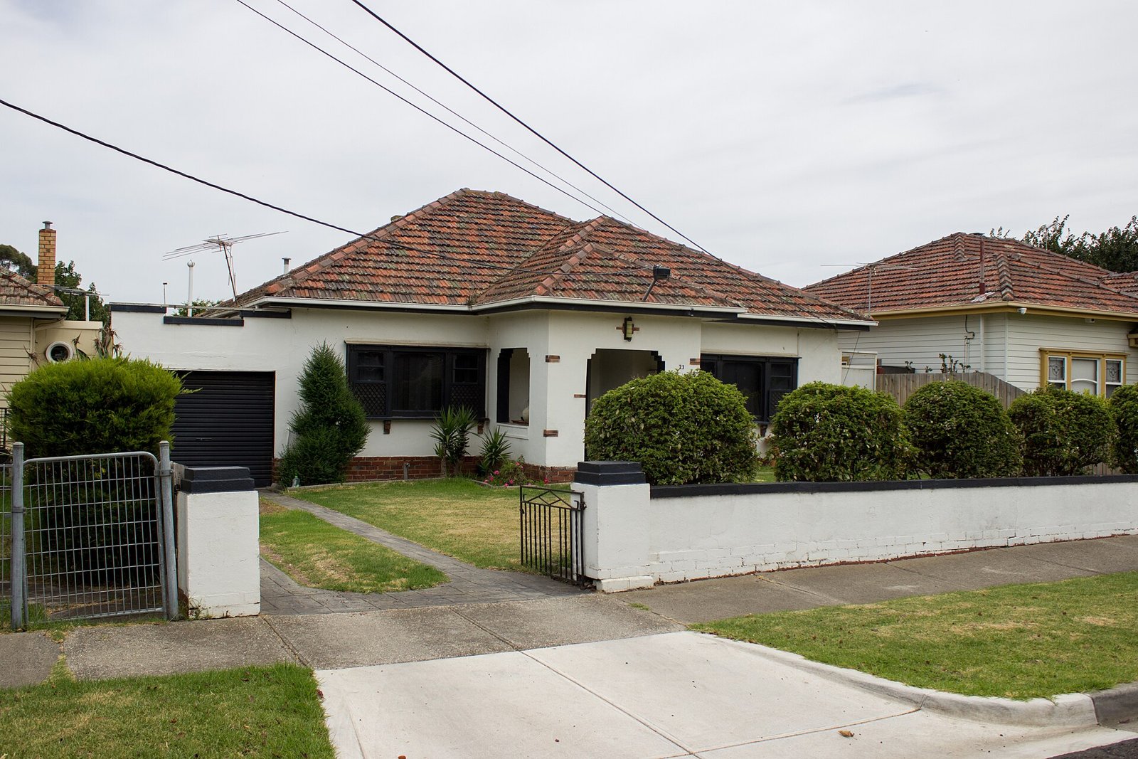 A single-story suburban house with a tiled roof and a front garden.