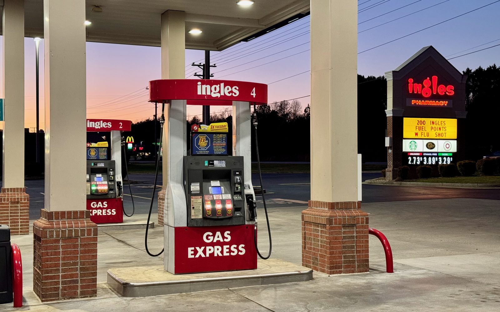 Gas station pumps at sunset