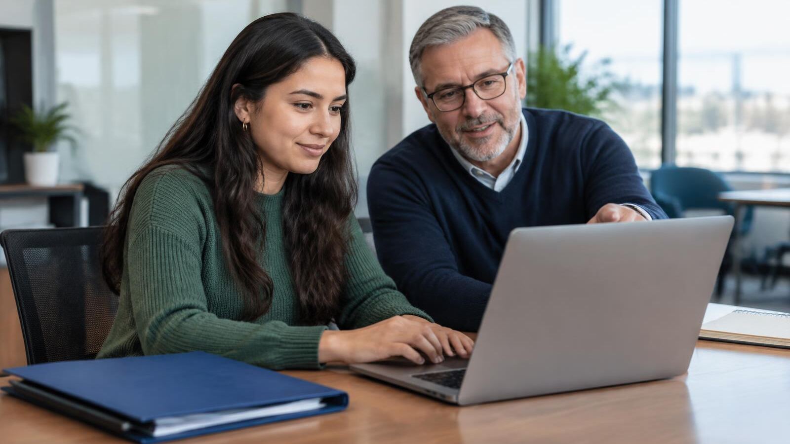 Colleague helping a young employee enroll in a workplace retirement plan