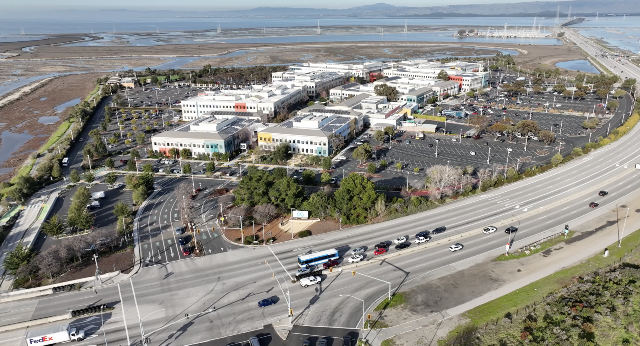 Aerial view of Meta Platforms' headquarters campus in Menlo Park, California, with the Meta sign near the road