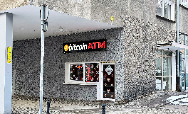 A storefront bitcoin ATM with a lit bitcoin logo sign, photographed in January 2026