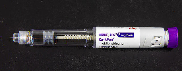 A Mounjaro KwikPen injection pen made by Eli Lilly, with the Lilly logo printed on the label